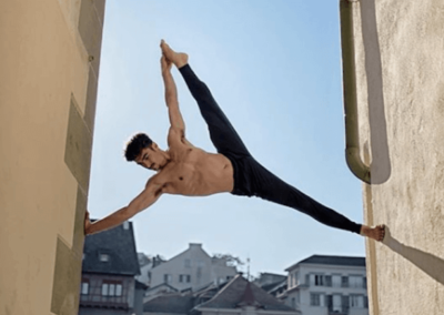 Matt Giordano stretching in the air between two house walls