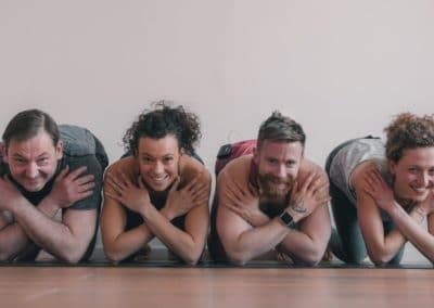 Four yogis crossing their arms in front of their chests