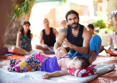 Thai massage instructor explaining a technique to his class