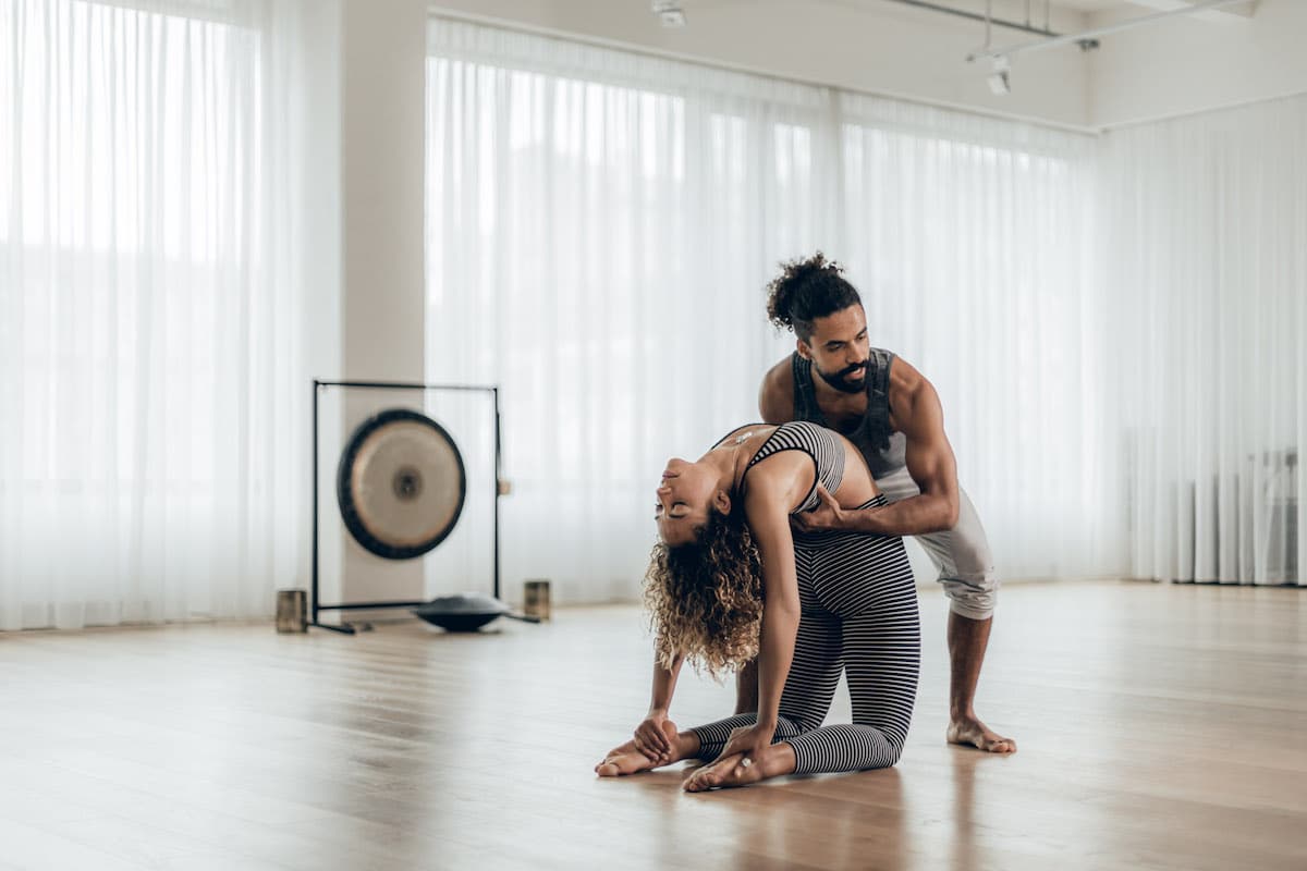 The Art of Adjustments: Understanding Physical Assists in Yoga